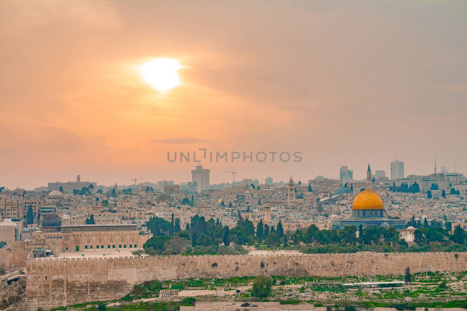 Panoramic view of Jerusalem old city and the Temple Mount during a dramatic colorful sunset. A view of the Dome of the Rock and Al Aqsa Mosque from the Mount of Olives in Jerusalem, Israel.