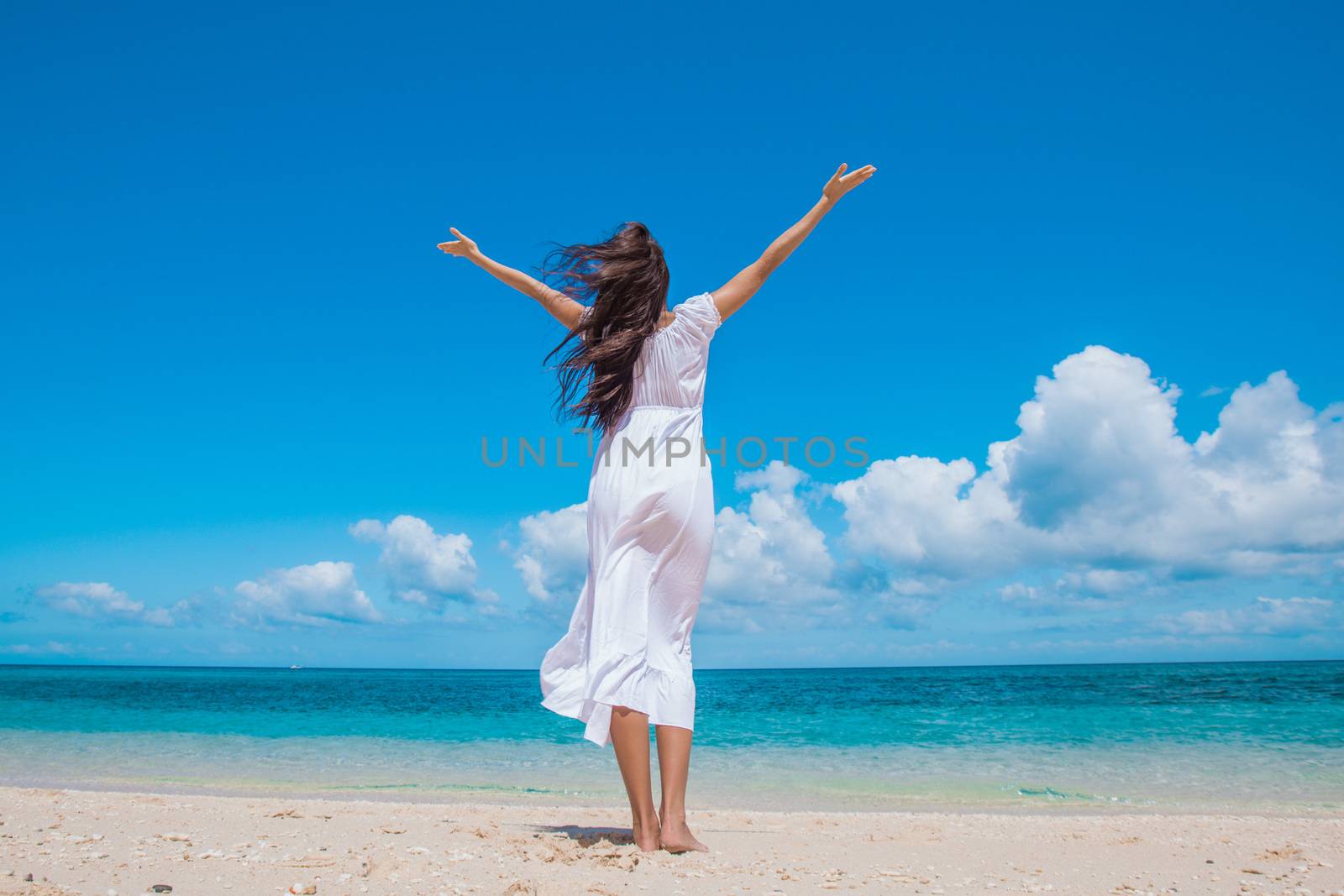 Woman in dress on beach by Yellowj