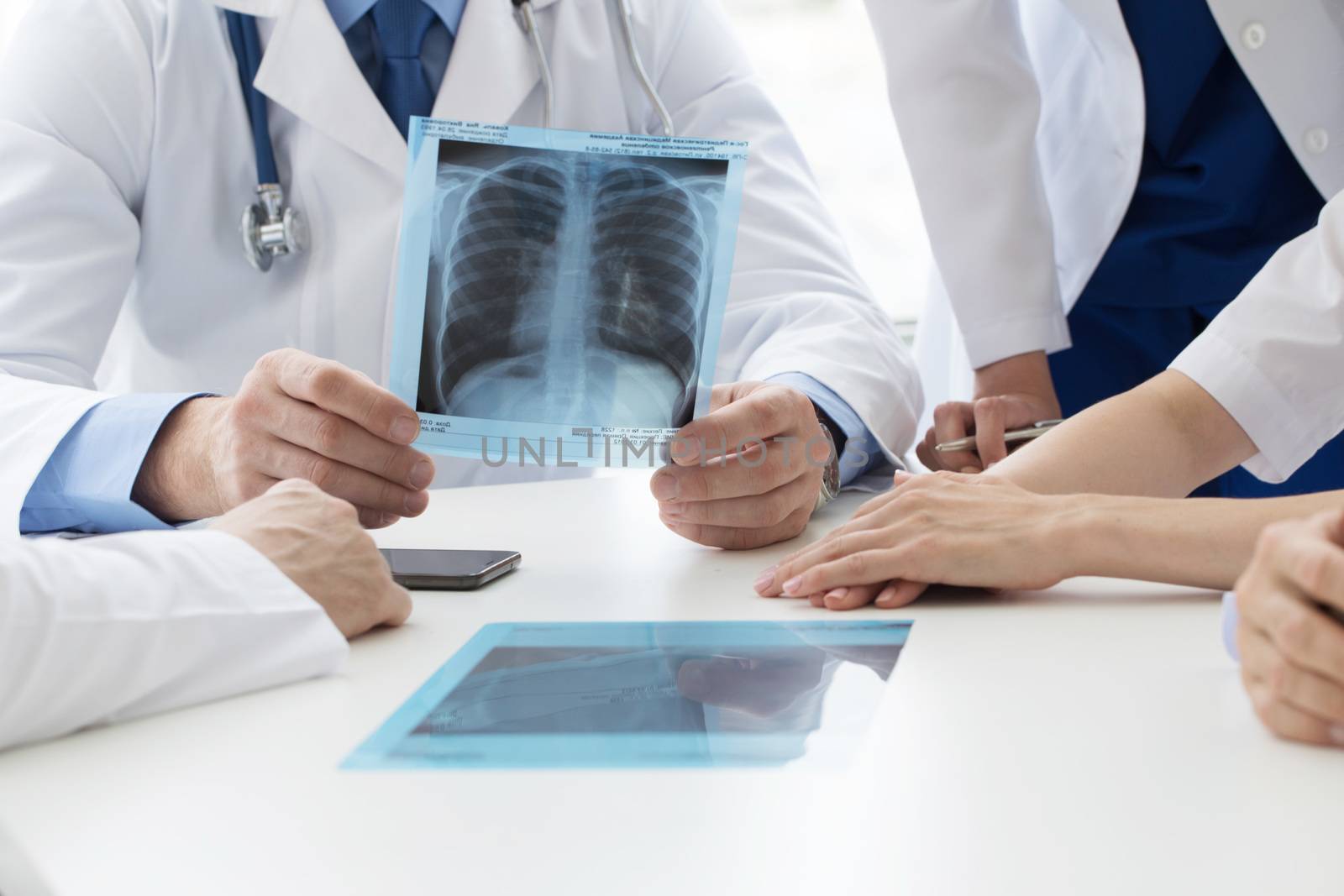 Group of doctors look and discuss x-ray in a clinic or hospital