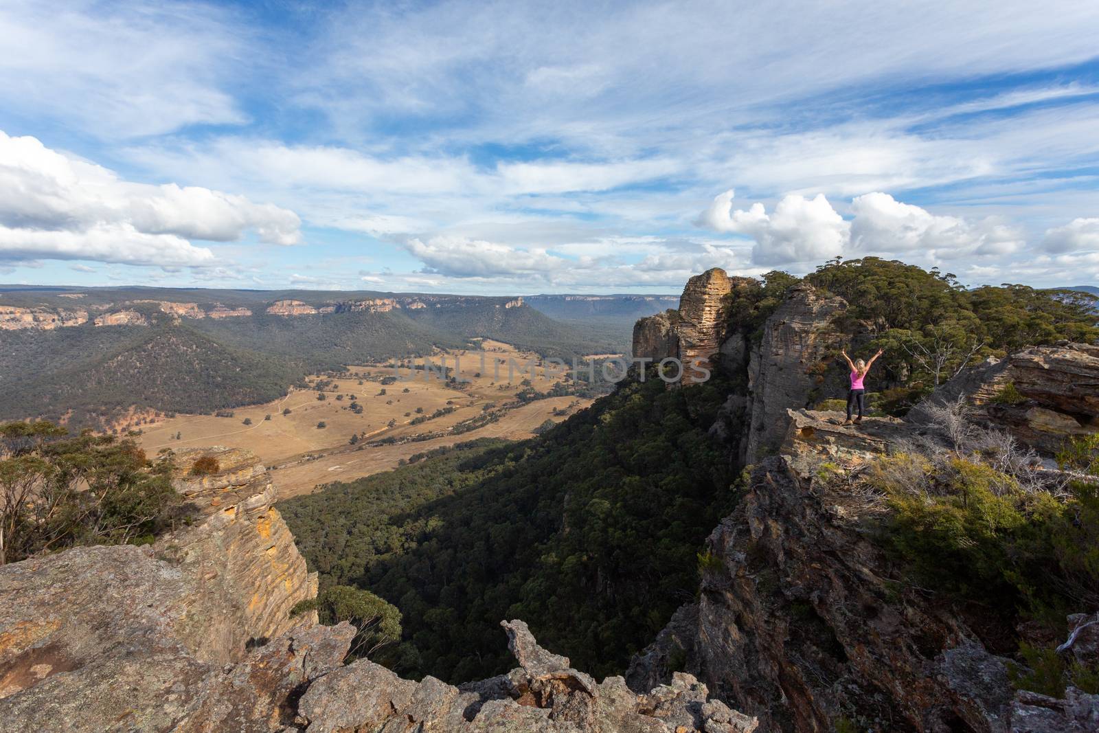 Adventurous hiker explorer reaching the top slab of Donkey Mountain in Australia by lovleah