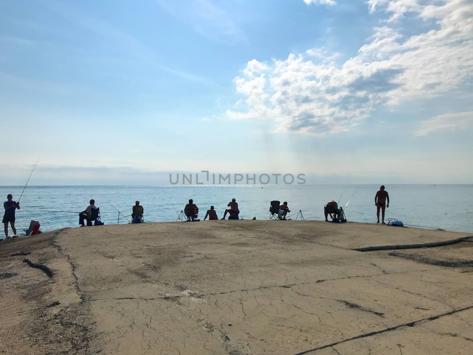 Pomorie, Bulgaria - July 16, 2019: Fishermen Hunt Fresh Fish Behind The Coasts Of The Sea Town.