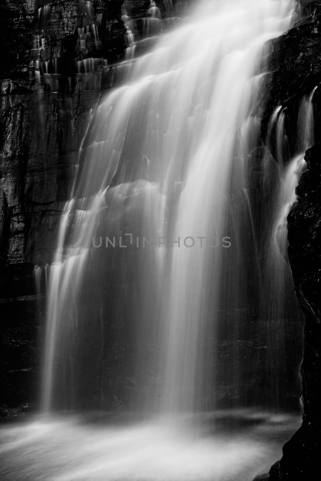 Beautiful and powerful waterfall flowing down cliff ledge