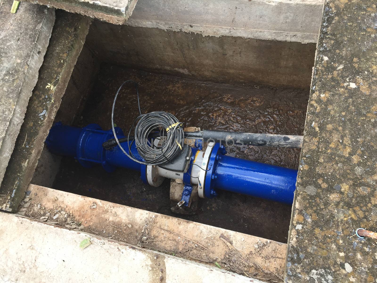 electromagnetic flow meter installed in the ground.
