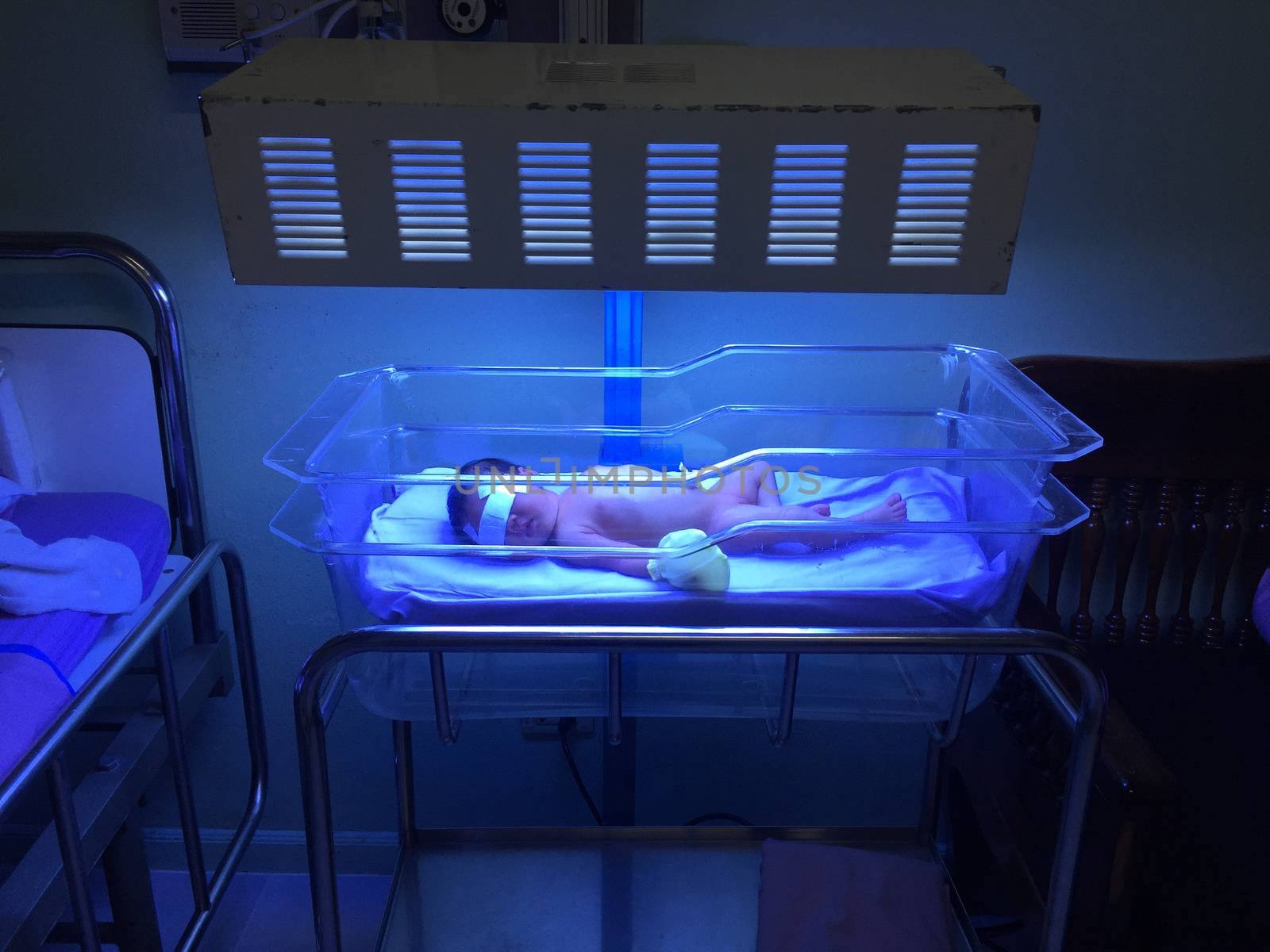 Newborns in incubators. blue light