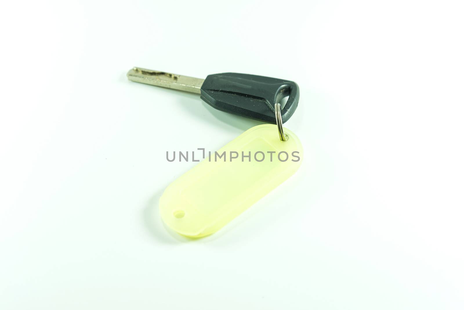 Key with label tag on white background.