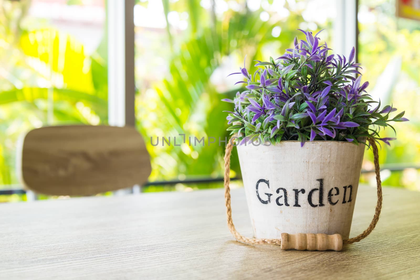 Purple flower pots placed on a wooden table.