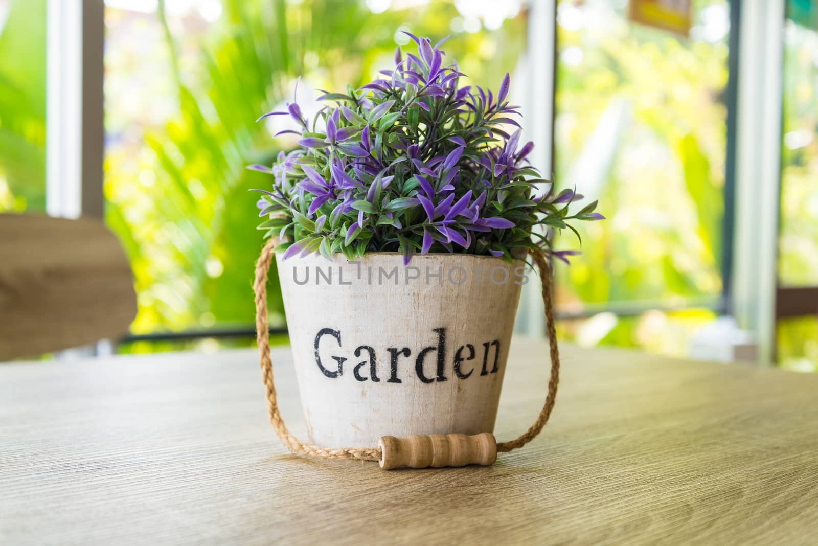 Purple flower pots placed on a wooden table.