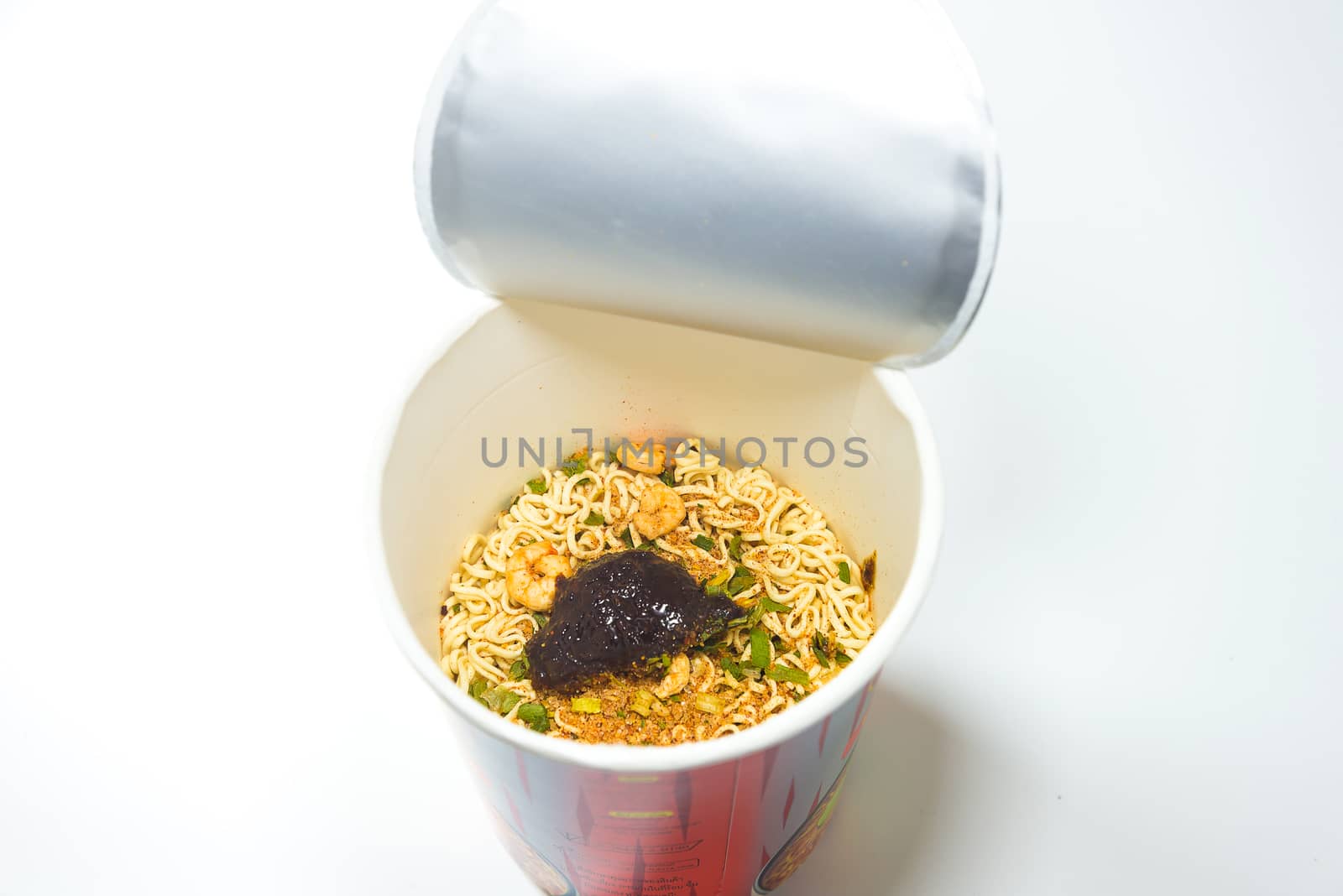 cooked instant cup noodle with ingredient on white background