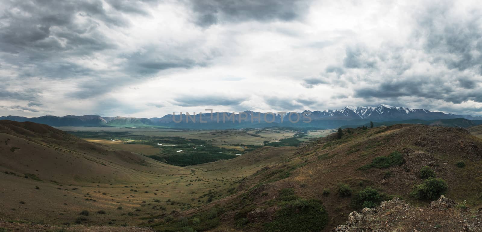 Panoramic picture of Kurai steppe and North-Chui ridge of Altai mountains, Russia. Cloud day.