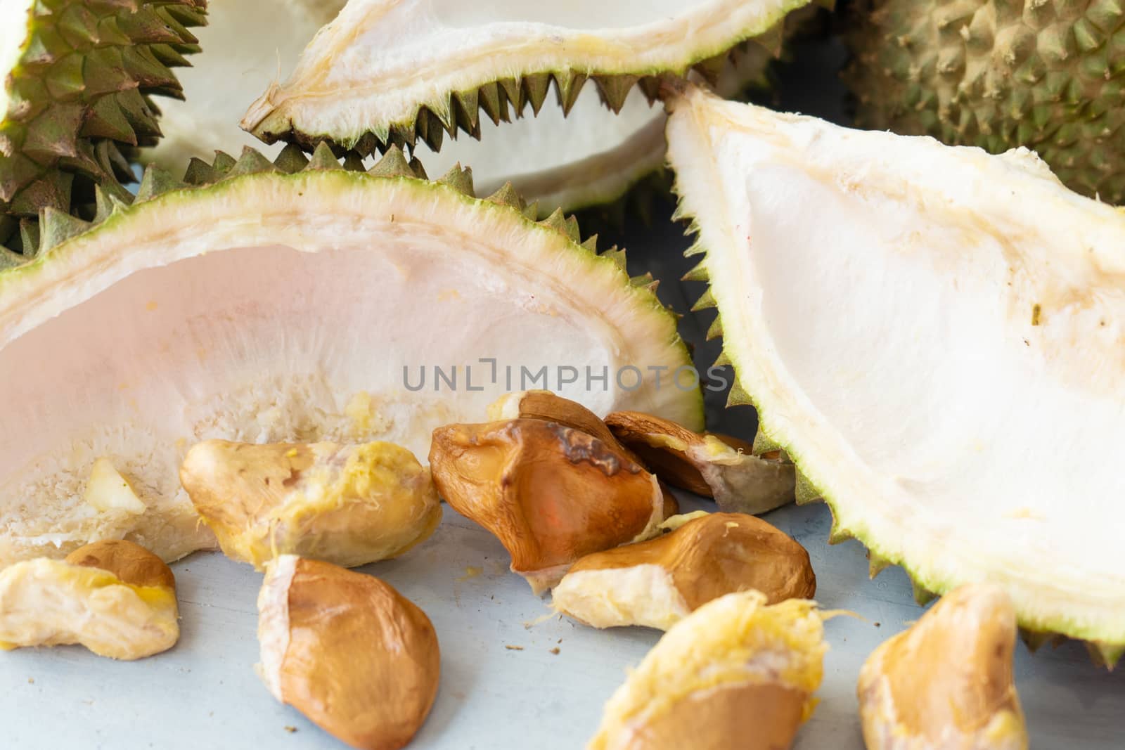 Leftover durian, shells and seeds on table.