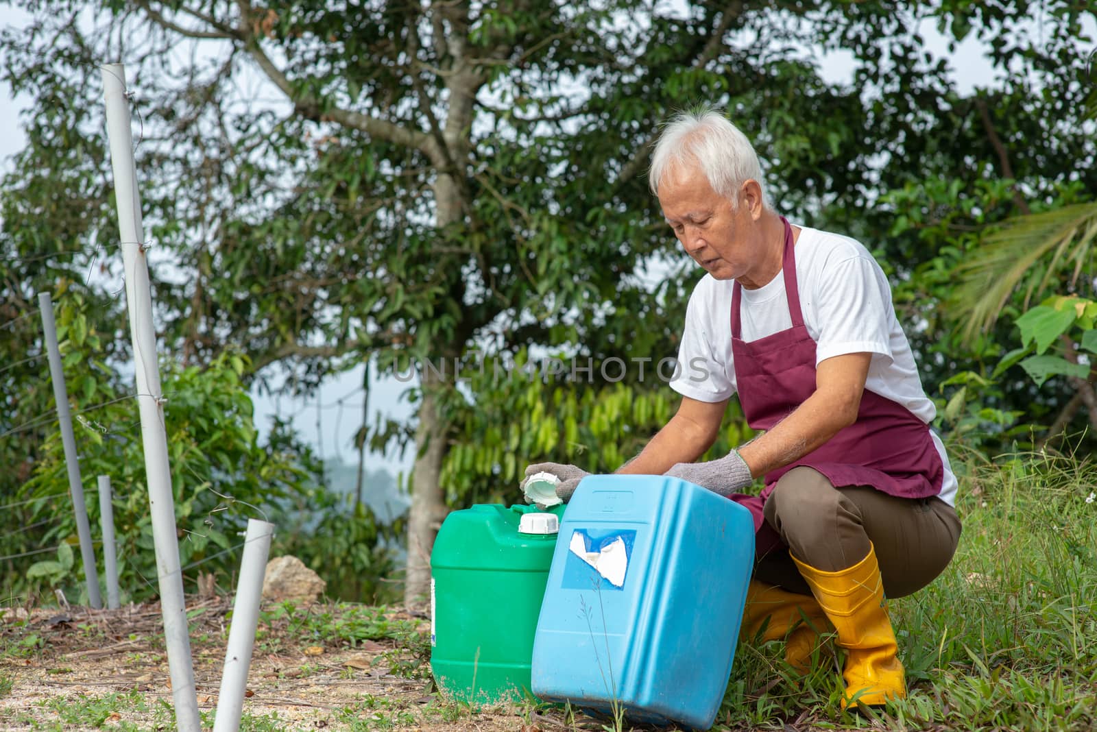 Farm worker checking container. by szefei