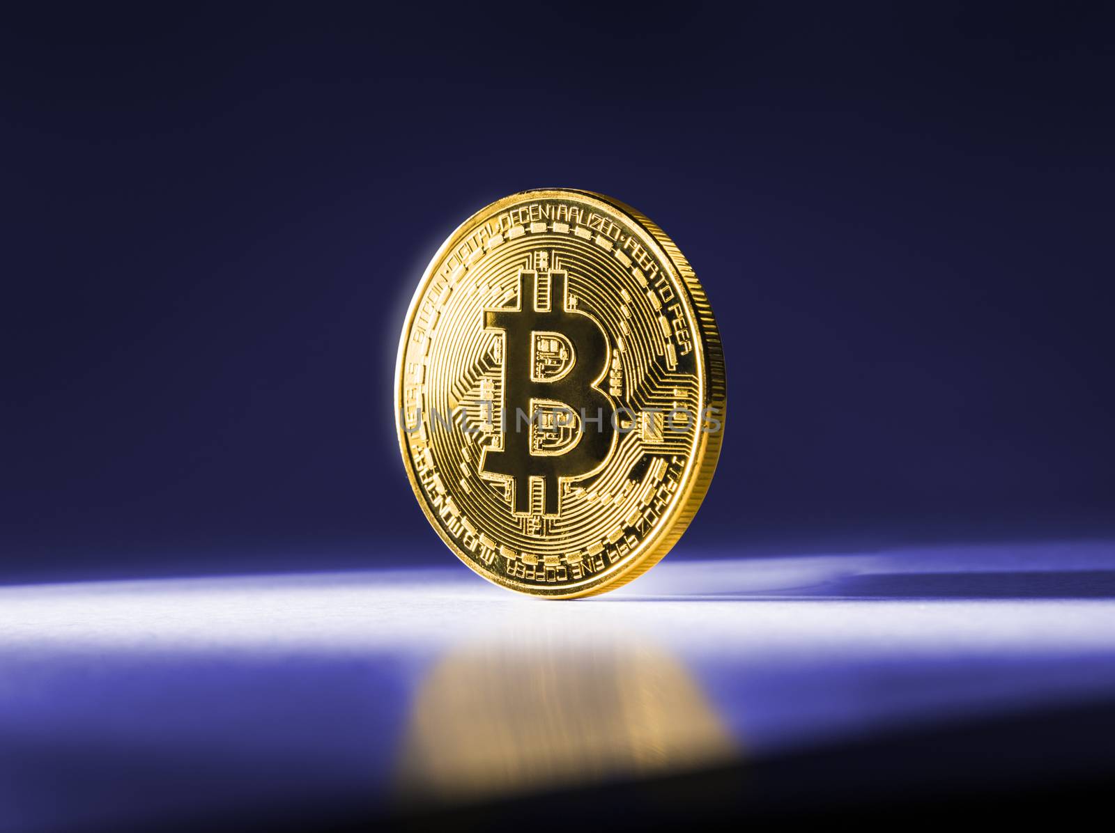 Gold coin Bitcoin on blue background. Cryptocurrency