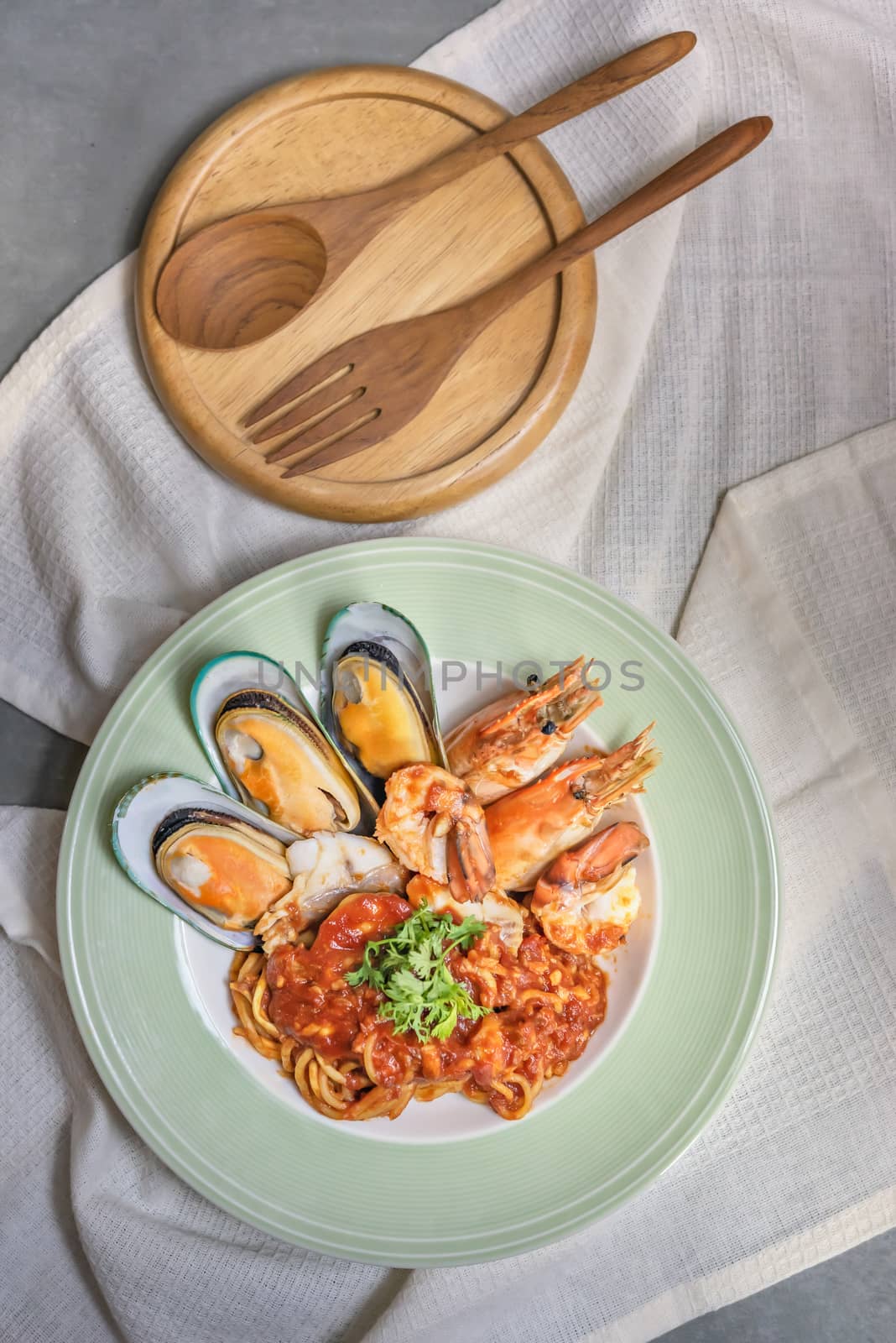 Spaghetti with seafood in tomato sauce on a plate