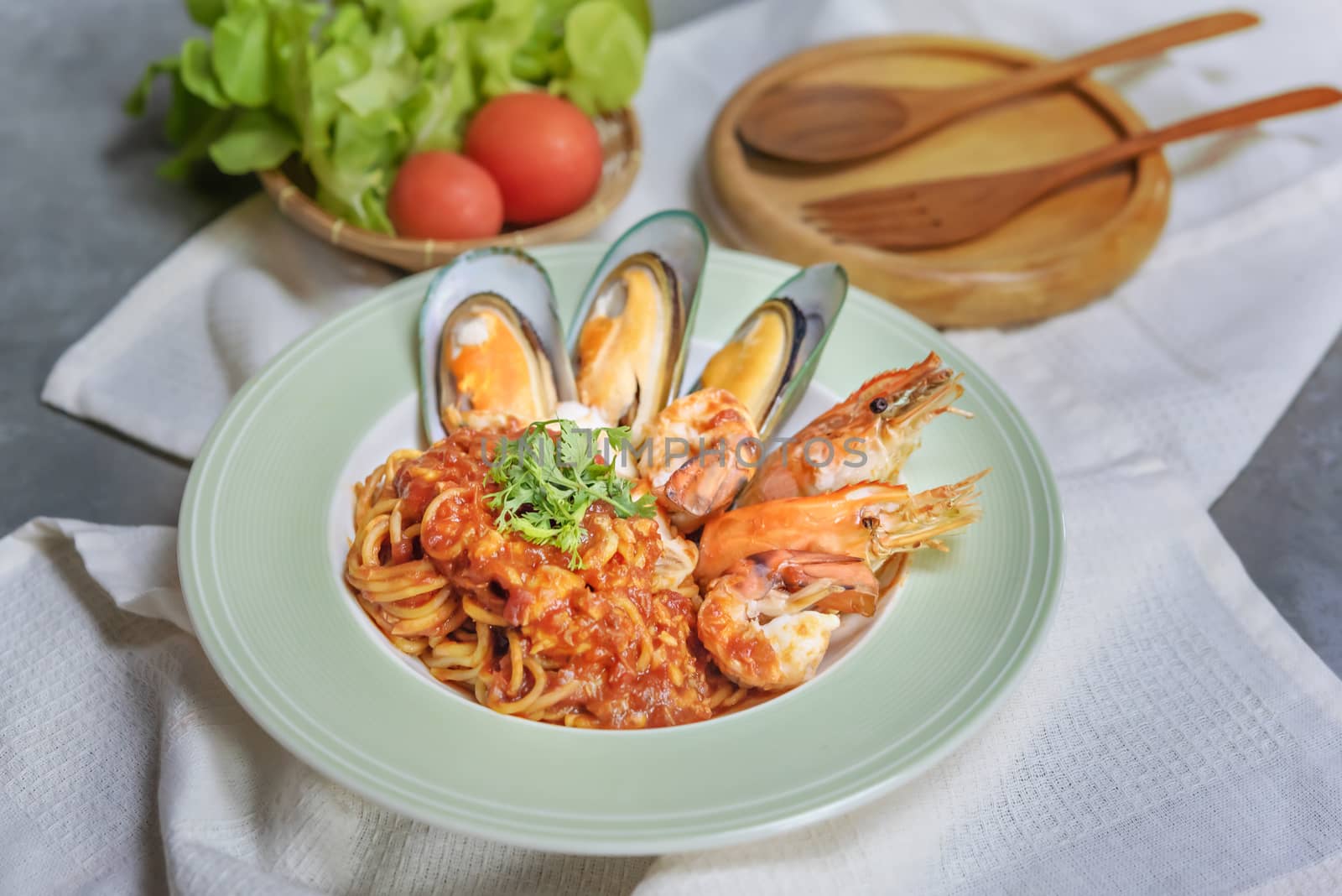 Spaghetti with seafood in tomato sauce on a plate