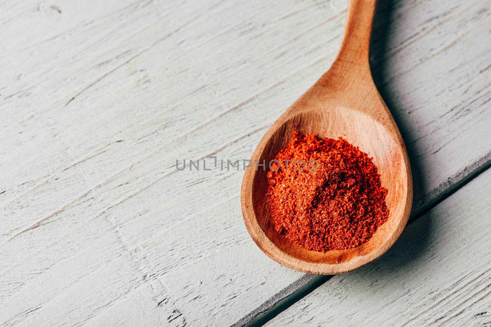 Wooden spoonful of red chili pepper powder