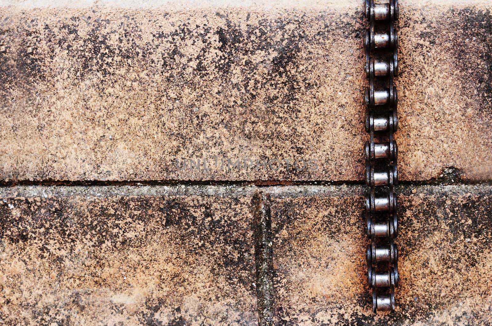 bicycle chain hanging on the brick wall.