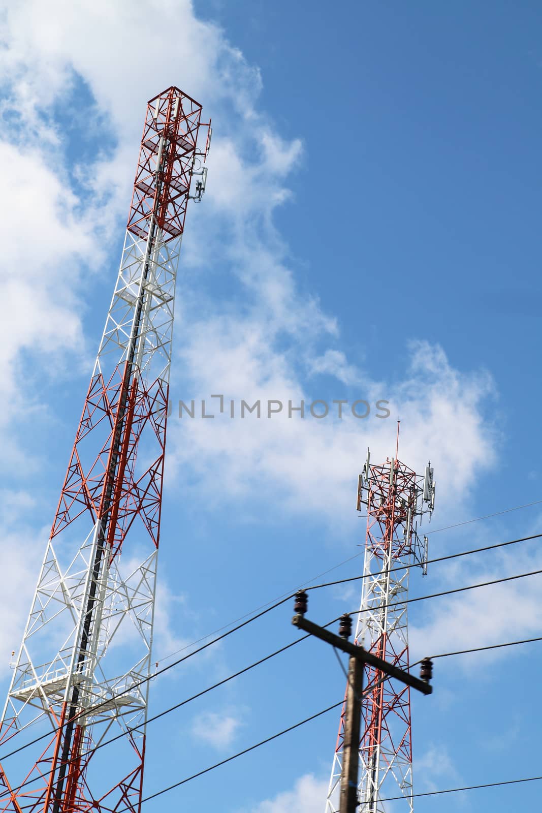 Two cell phone tower in clound and blue sky.