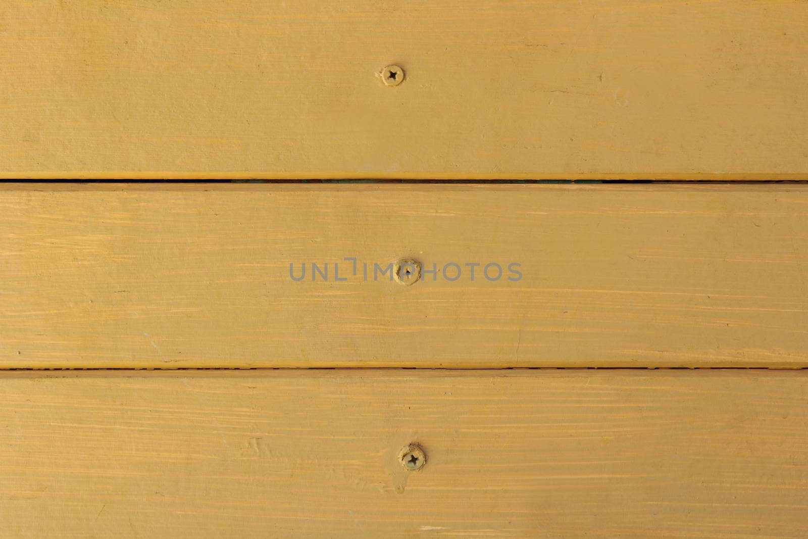 wooden wall with nails and paint by yellow color.