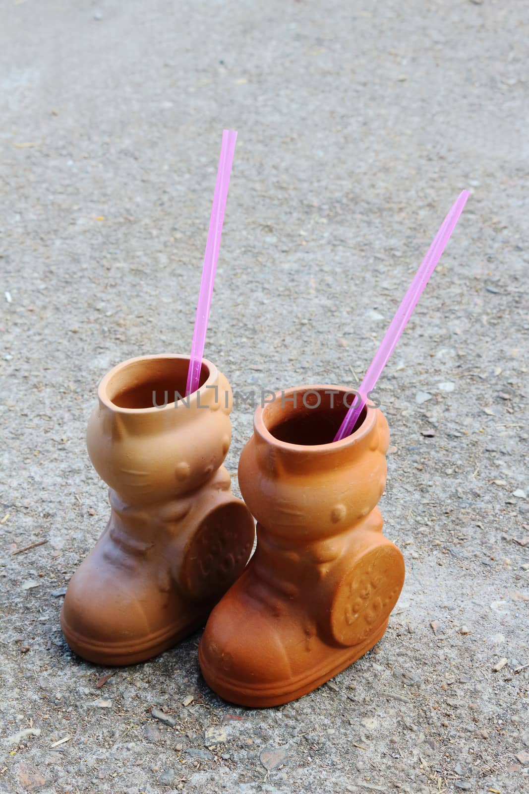 pottery for drink in boots shape.