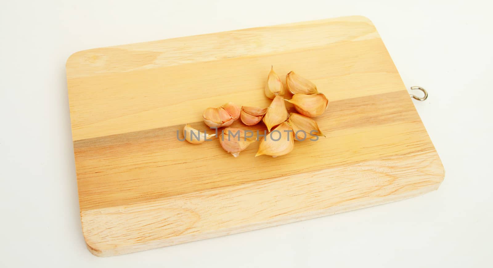 pieces of garlics on chopping Board.