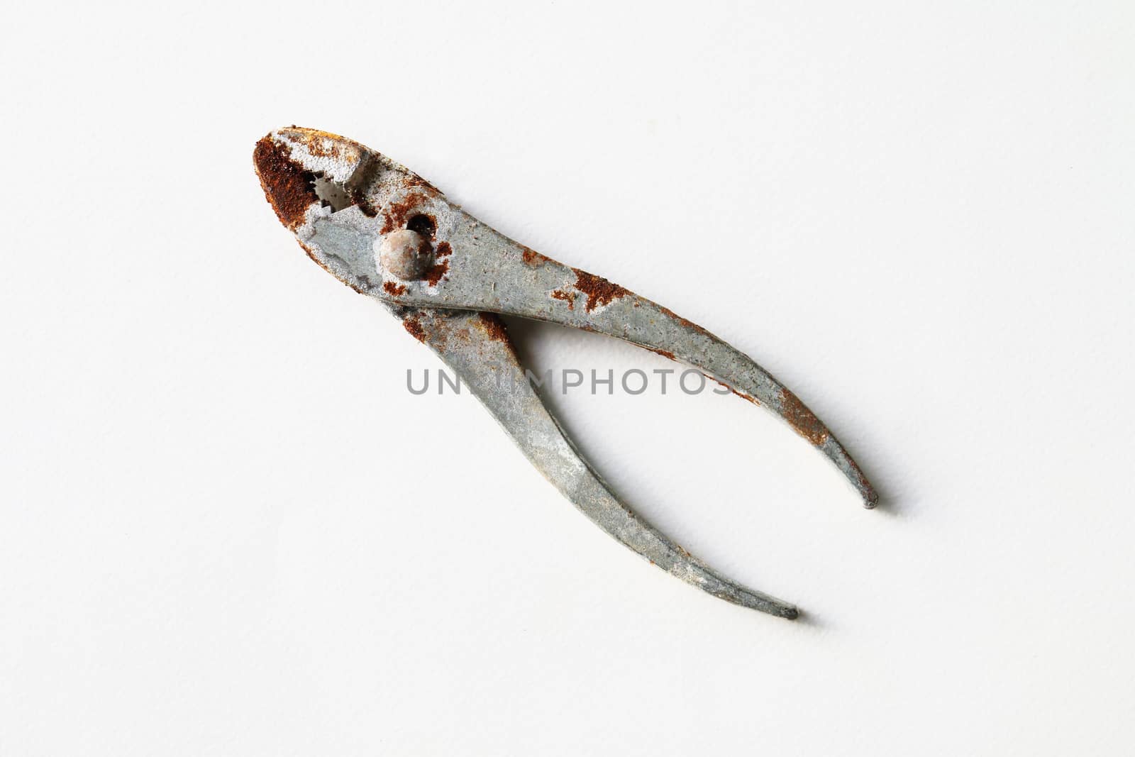 rusty steel pliers on white background.