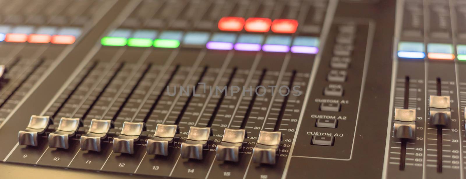 Panorama close-up buttons equipment for sound mixer control. Mixer for musician DJ and sound engineers. Mixing DJ remote with colorful neon light. Night club, nightlife concept