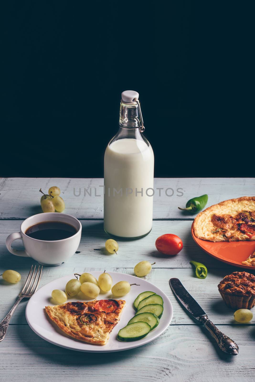Frittata and fruits, vegetables, bottle of milk, cup of coffee. by Seva_blsv
