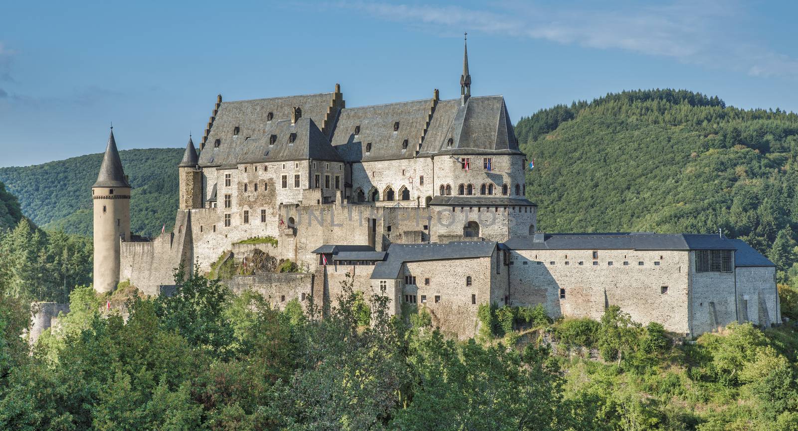 The old and restored Vianden castle on a blue sky background , Luxembourg, Europe