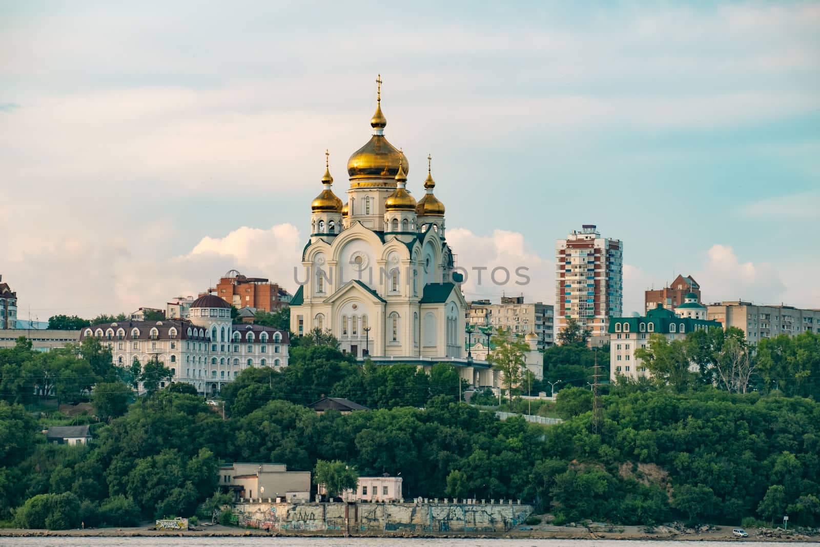 View of the city of Khabarovsk from the Amur river. Urban landscape in the evening at sunset