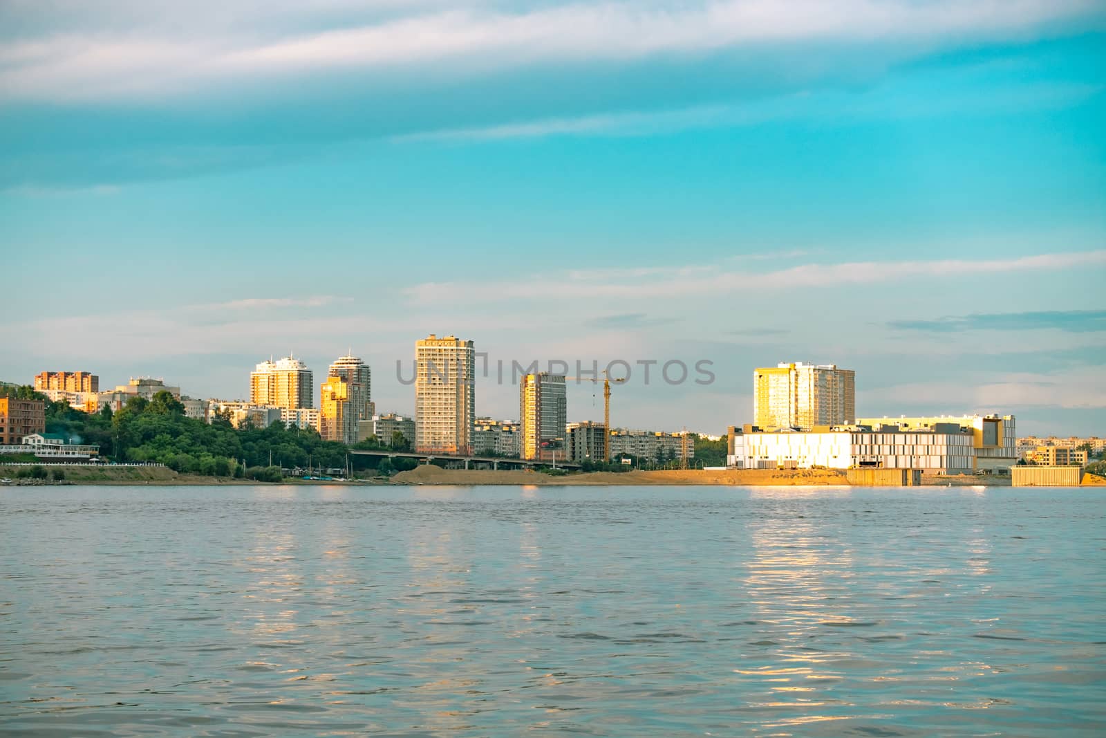 View of the city of Khabarovsk from the Amur river. Urban landscape in the evening at sunset