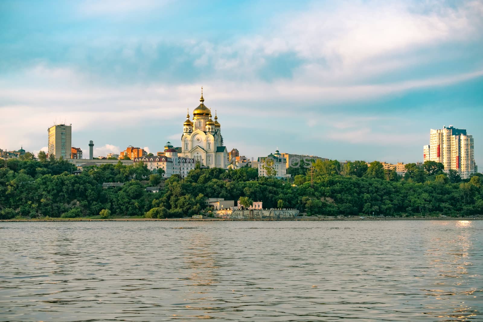 View of the city of Khabarovsk from the Amur river. Urban landscape in the evening at sunset. by rdv27