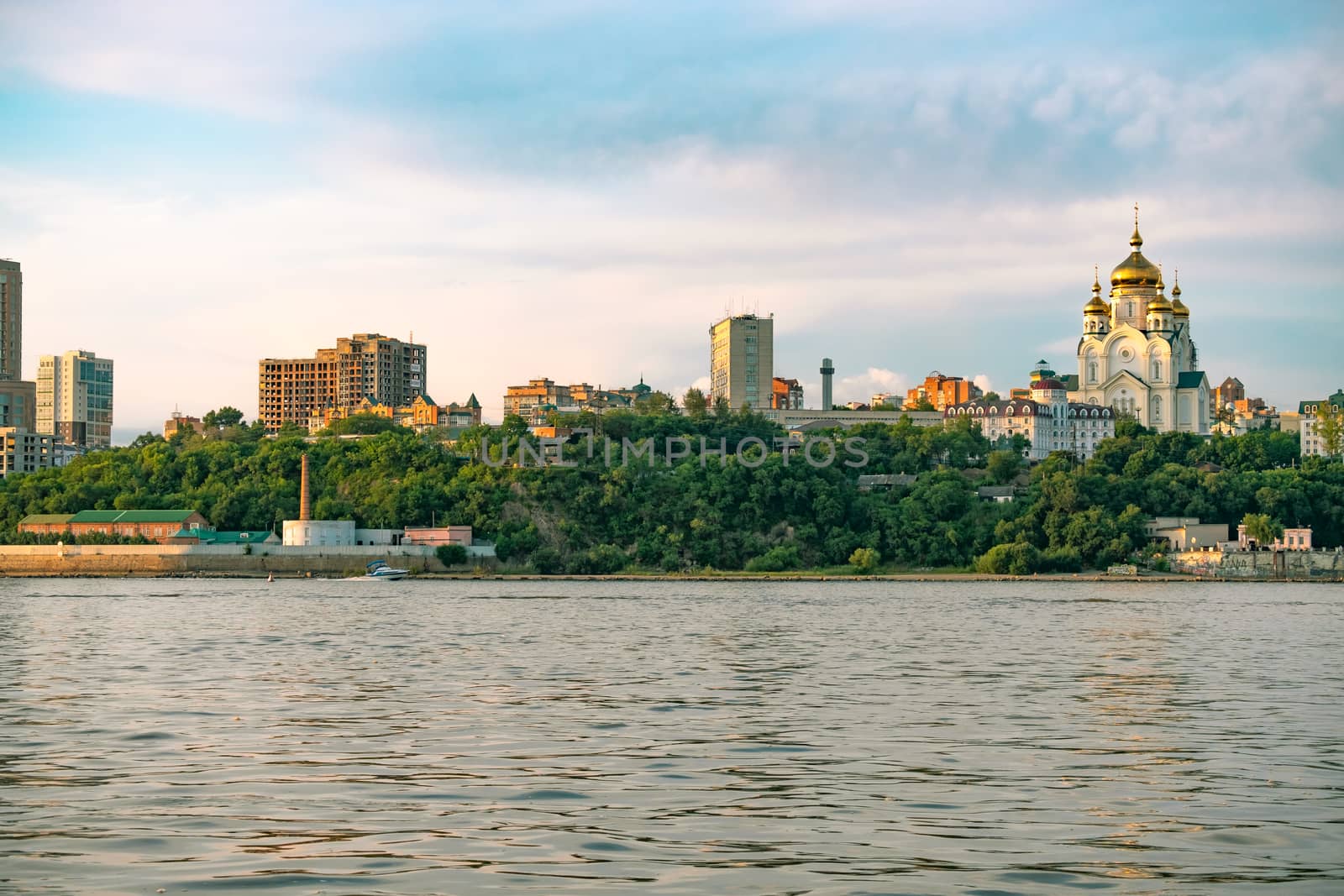 View of the city of Khabarovsk from the Amur river. Urban landscape in the evening at sunset. by rdv27