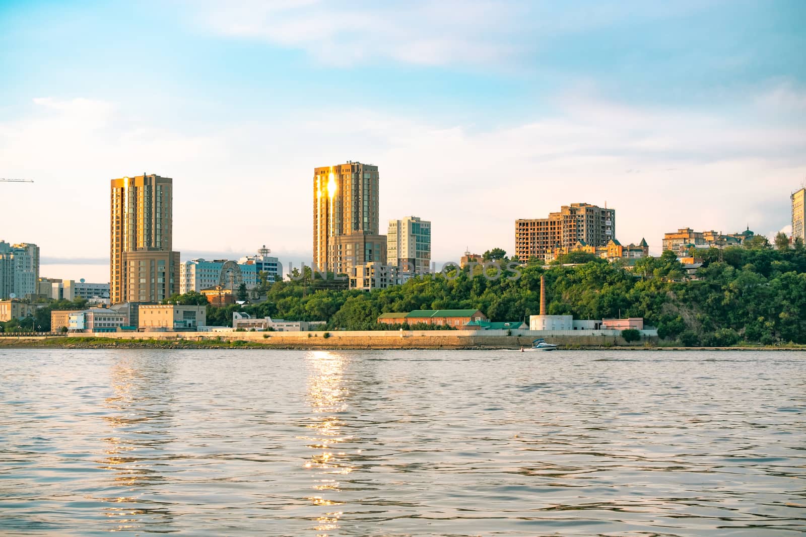 View of the city of Khabarovsk from the Amur river. Urban landscape in the evening at sunset