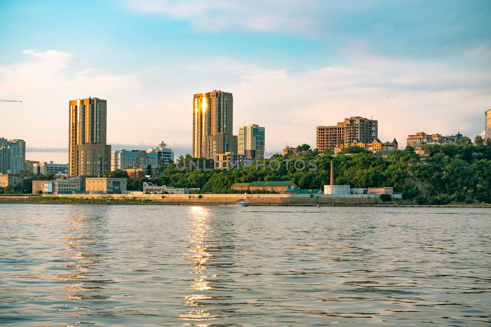 View of the city of Khabarovsk from the Amur river. Urban landscape in the evening at sunset