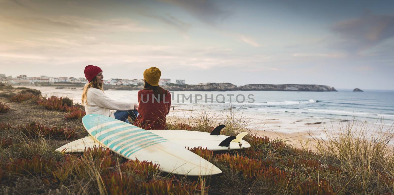 Surfer girls at the beach by Iko