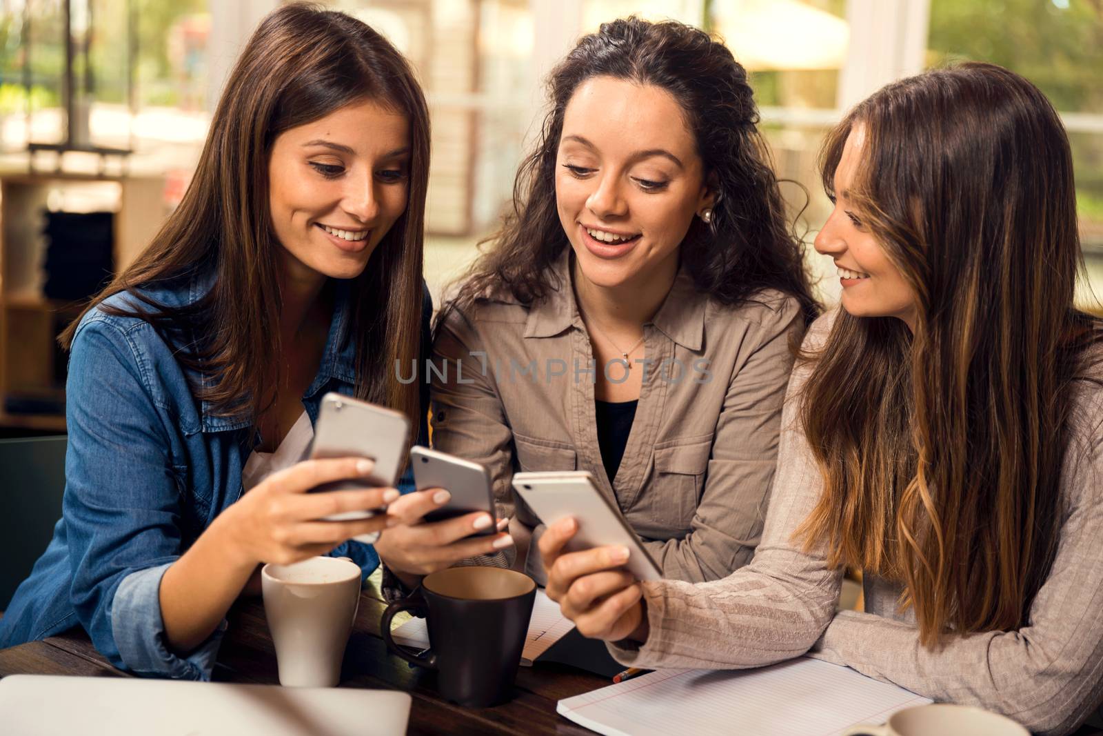 Group of girls making a pause on the studies for some gossip