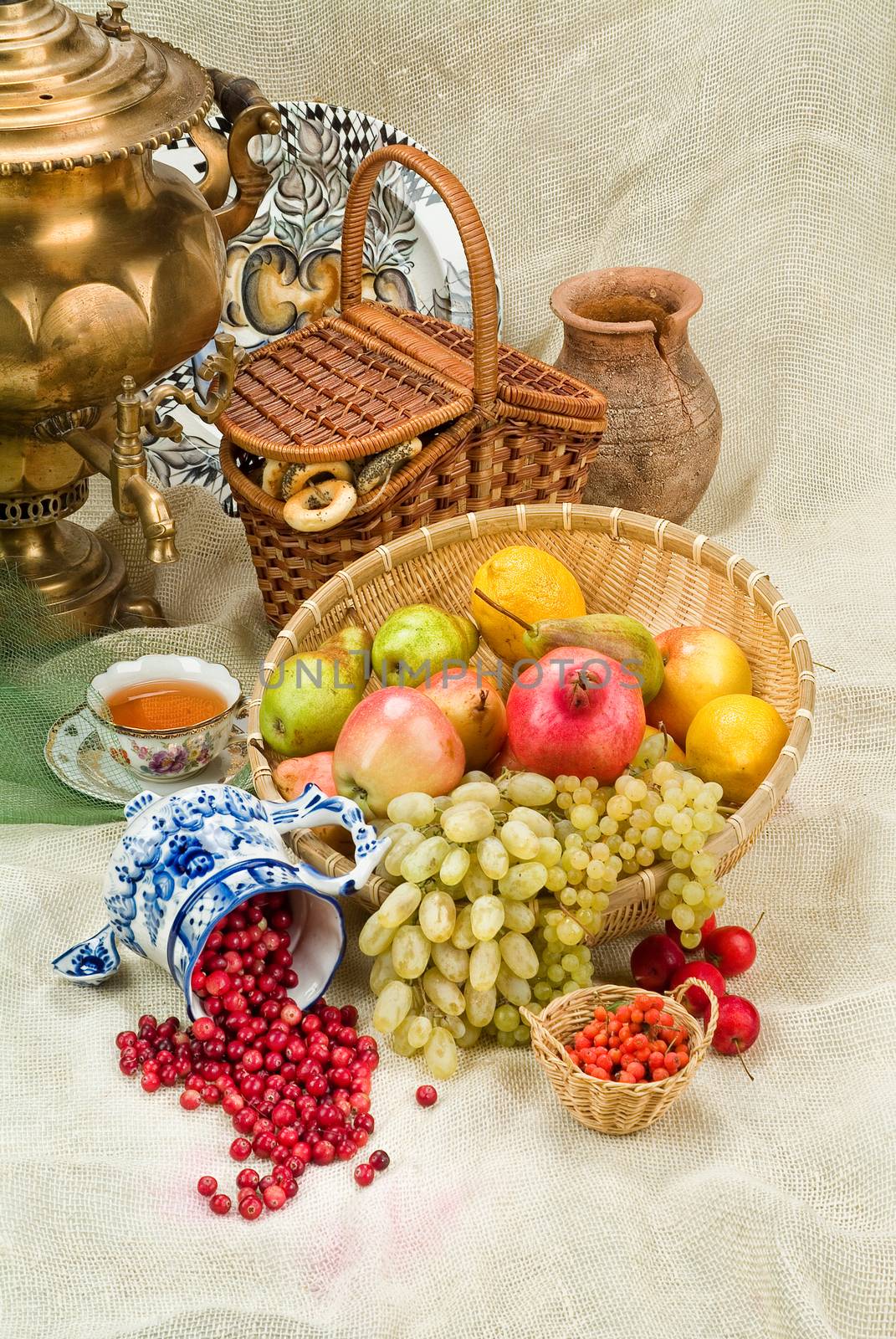 Russian traditional water boiler, flowers and berries on a studio background