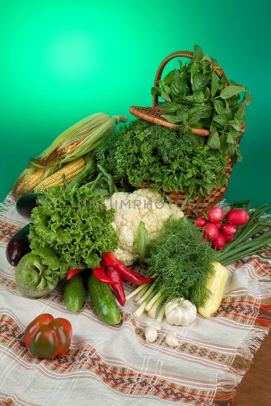 Wicker basket and vegetables on a studio background