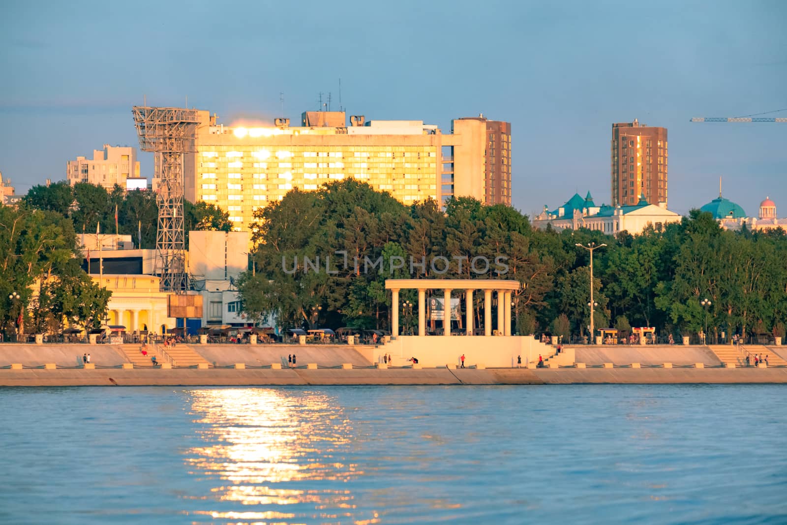 View of the city of Khabarovsk from the Amur river. Urban landscape in the evening at sunset. by rdv27