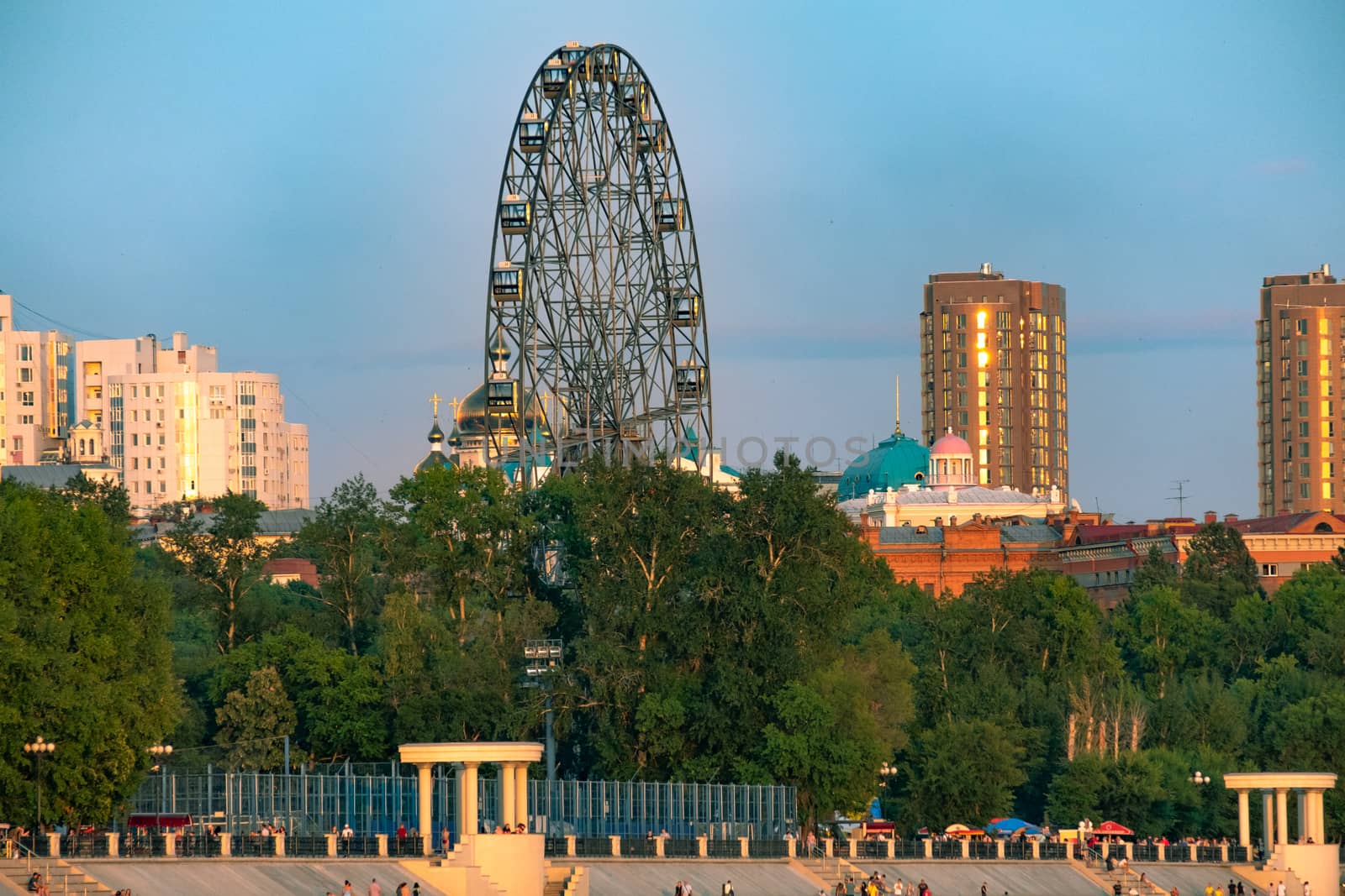 View of the city of Khabarovsk from the Amur river. Urban landscape in the evening at sunset. by rdv27