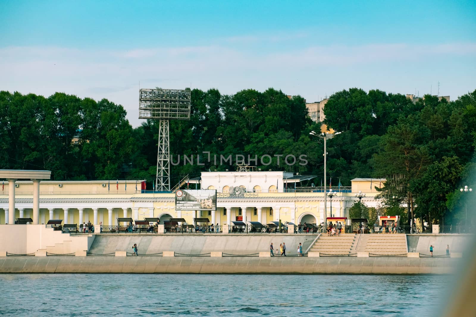 View of the city of Khabarovsk from the Amur river. Urban landscape in the evening at sunset