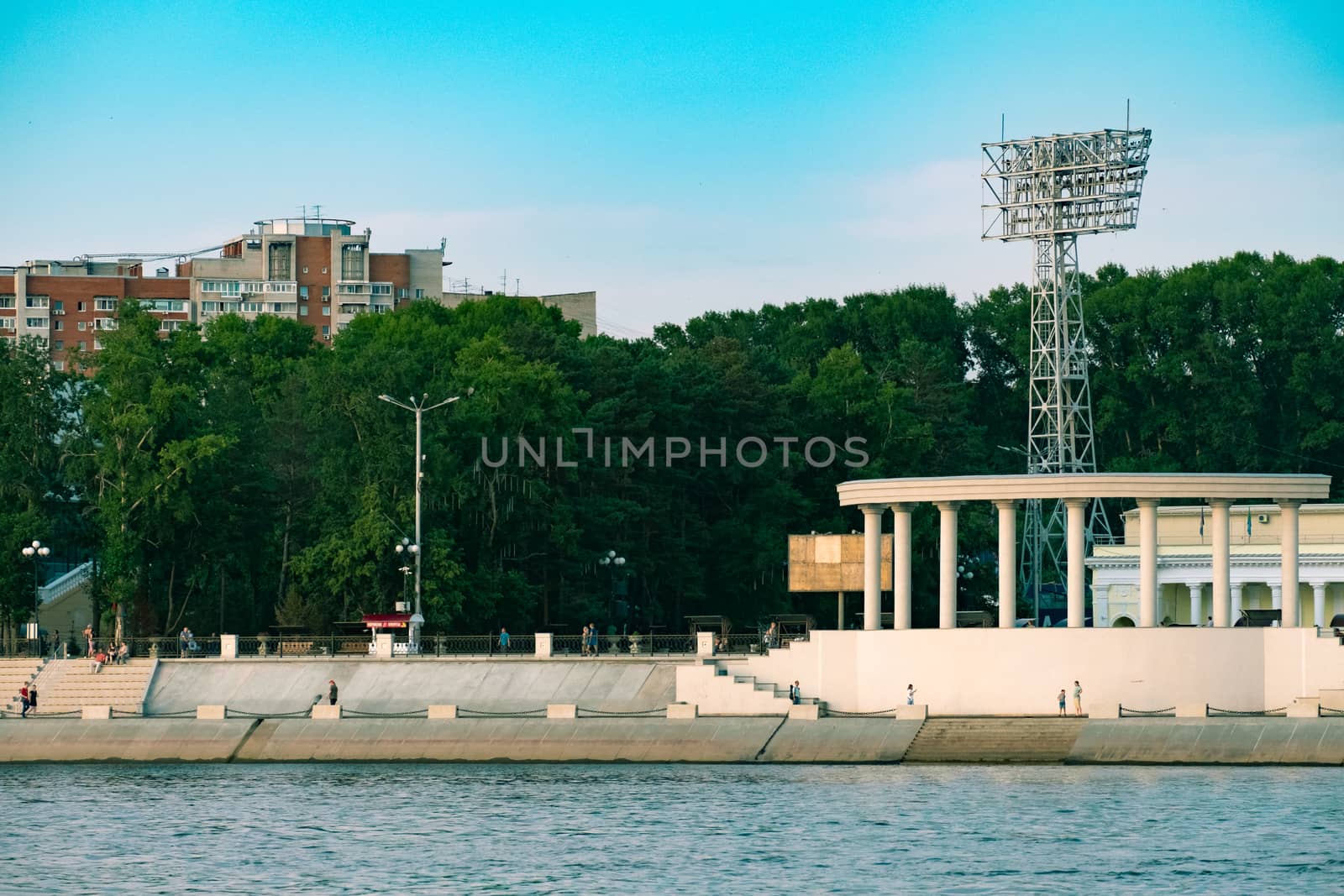 View of the city of Khabarovsk from the Amur river. Urban landscape in the evening at sunset