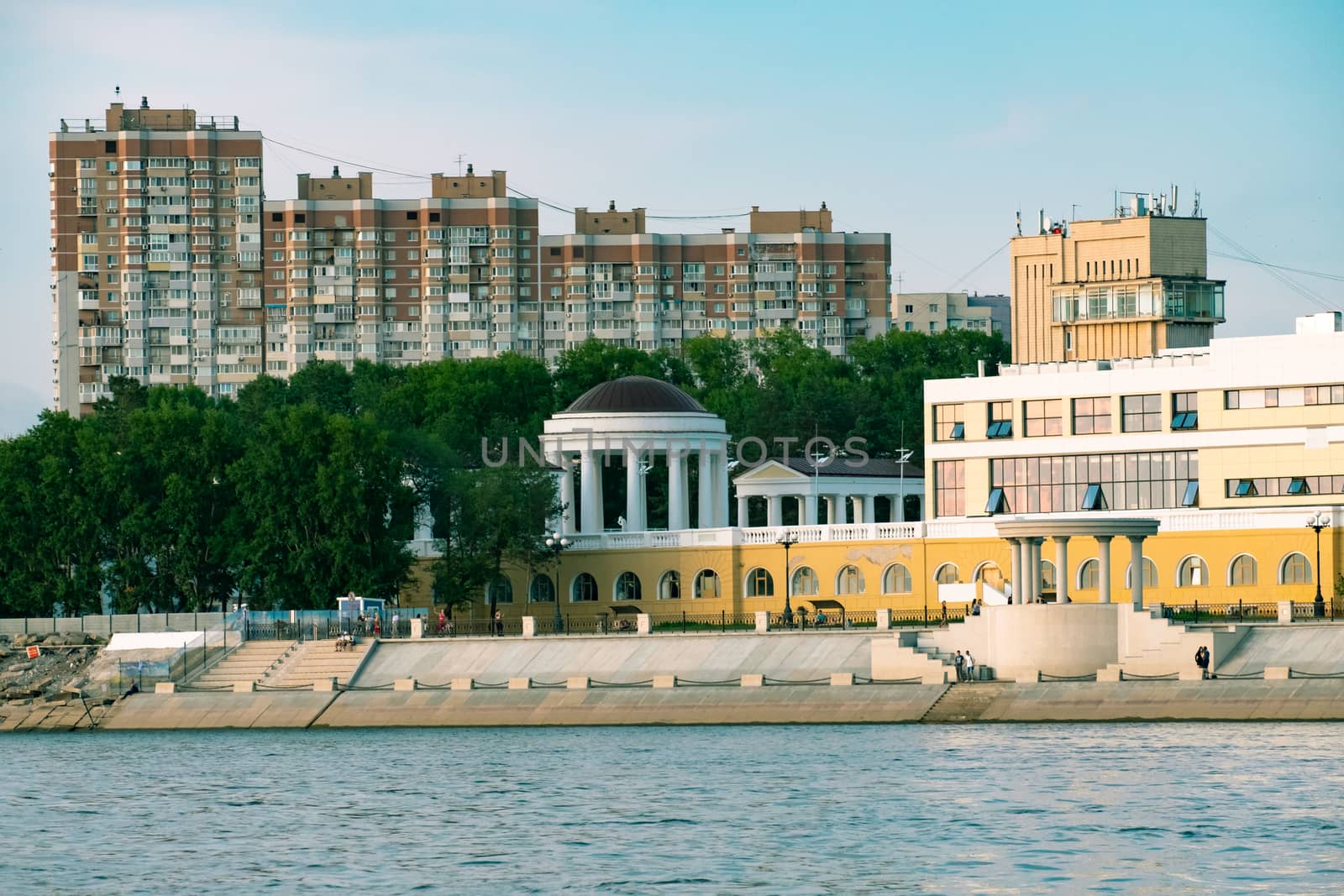 View of the city of Khabarovsk from the Amur river. Urban landscape in the evening at sunset. by rdv27