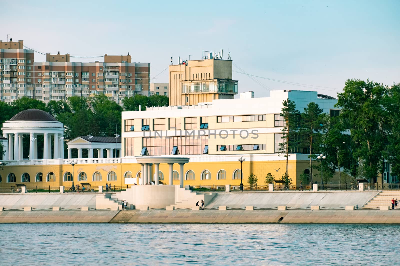 View of the city of Khabarovsk from the Amur river. Urban landscape in the evening at sunset. by rdv27