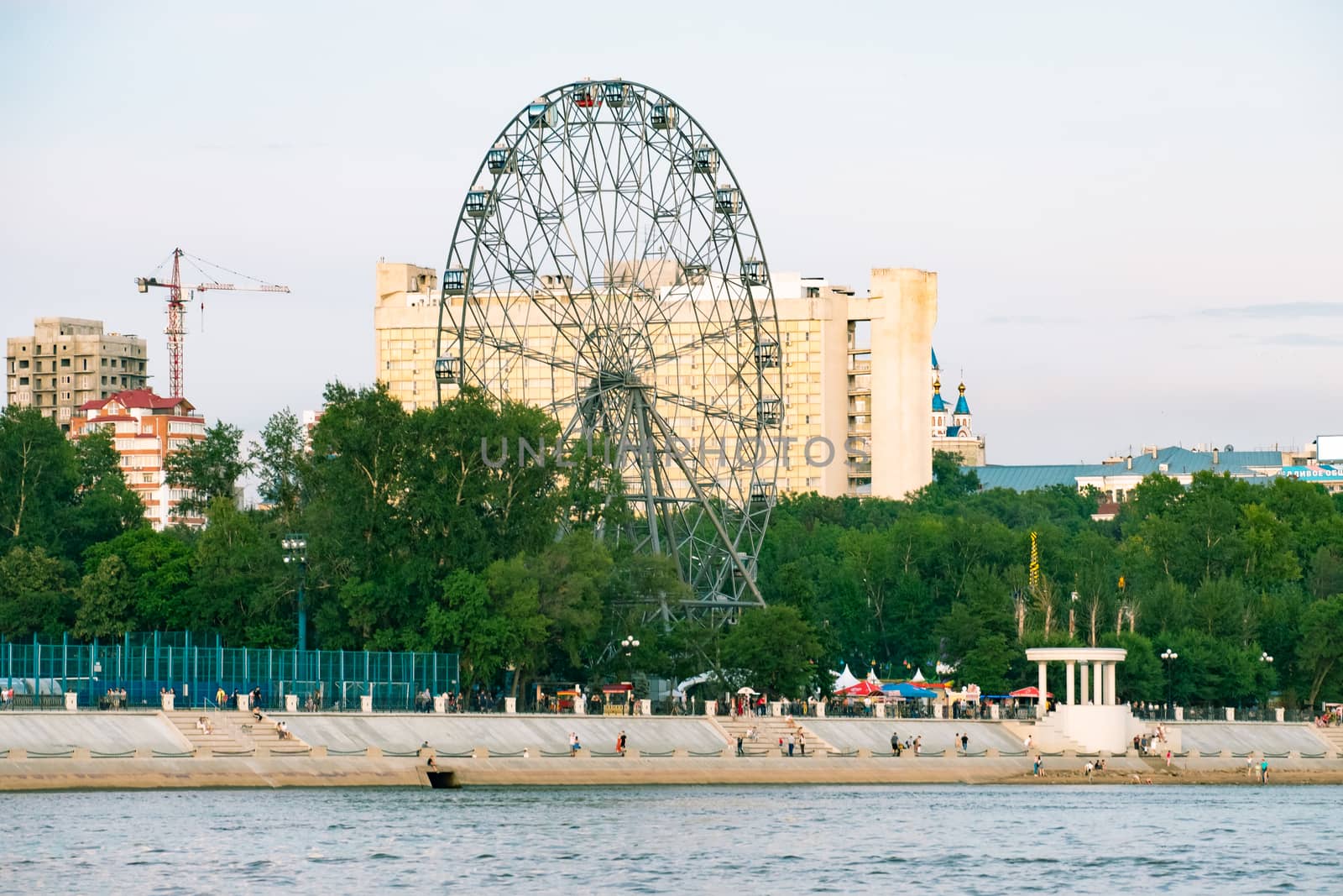 View of the city of Khabarovsk from the Amur river. Urban landscape in the evening at sunset