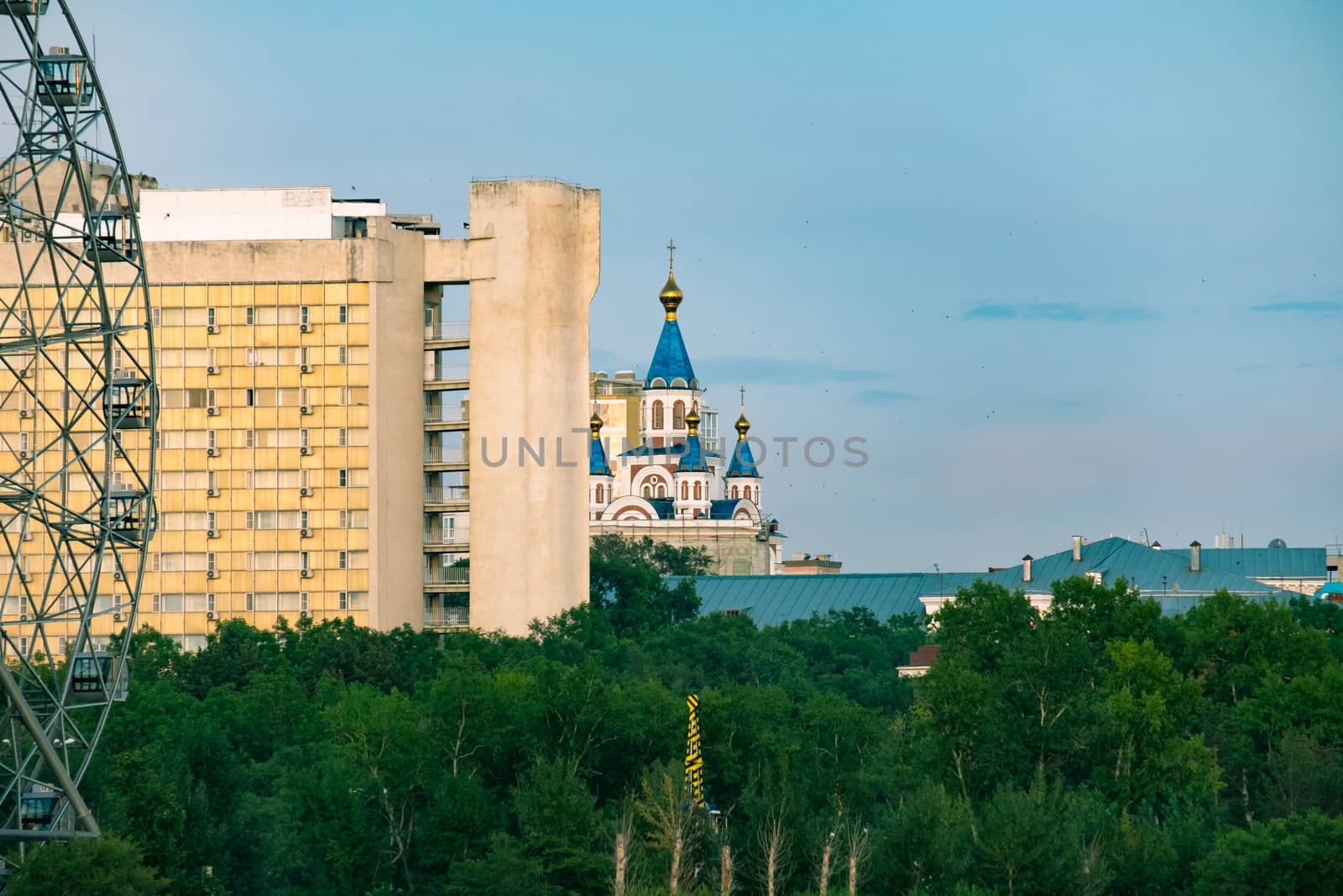 View of the city of Khabarovsk from the Amur river. Urban landscape in the evening at sunset