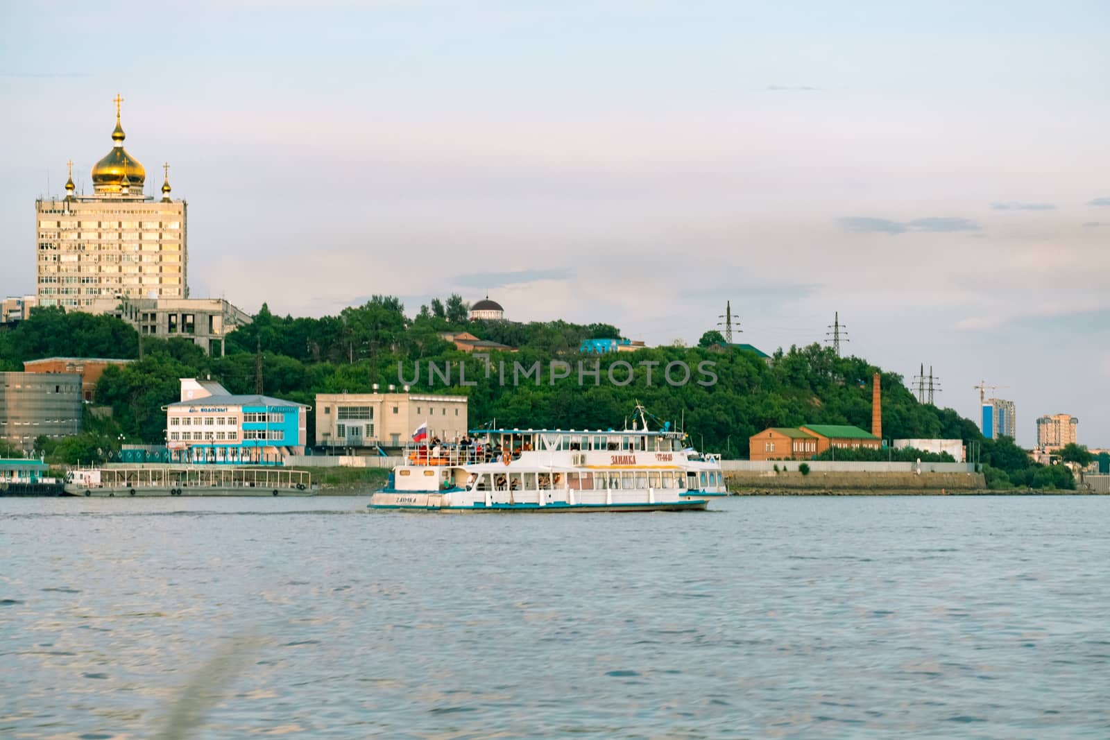 View of the city of Khabarovsk from the Amur river. Urban landscape in the evening at sunset. by rdv27