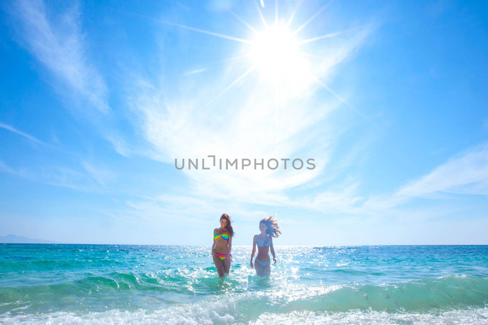 Women in bikni run to beach by Yellowj