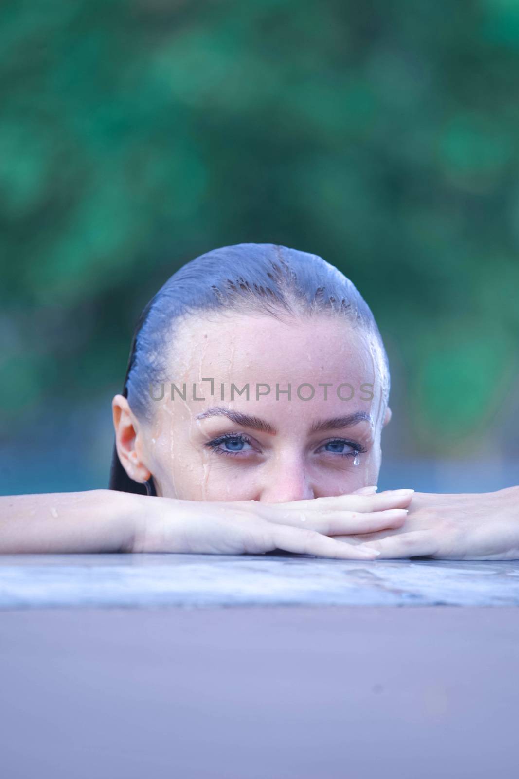 Portrait of a beautiful woman posing by the pool