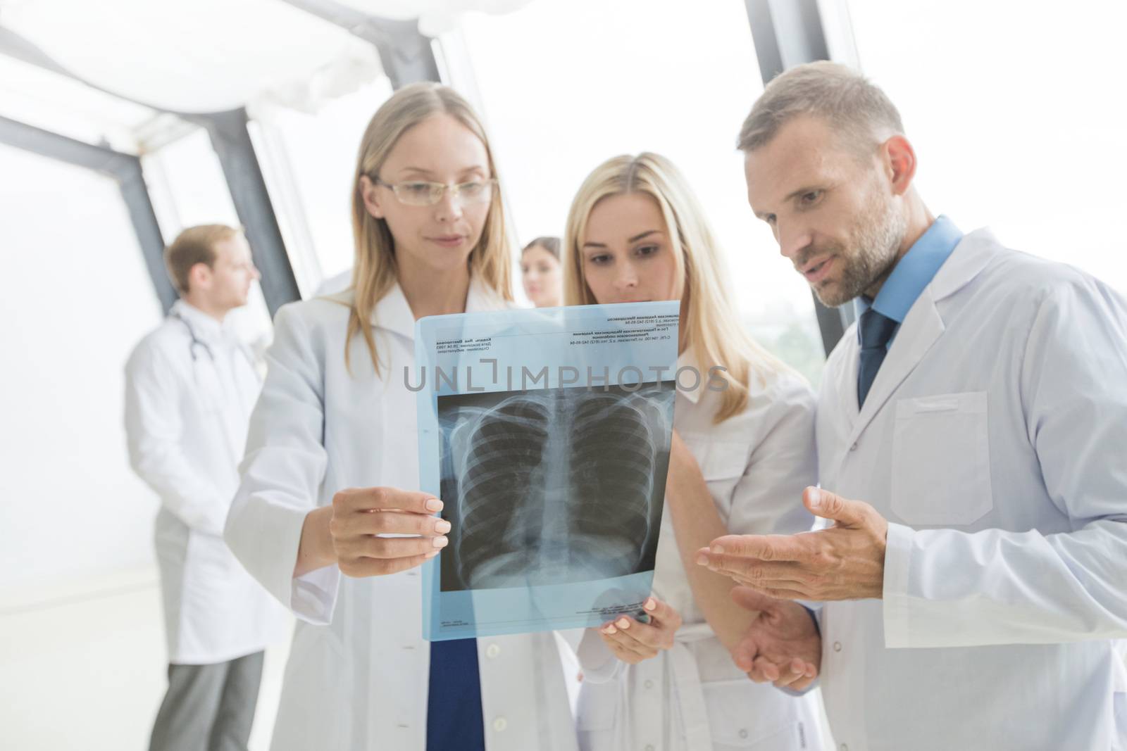 Group of doctors look and discuss x-ray in a clinic or hospital